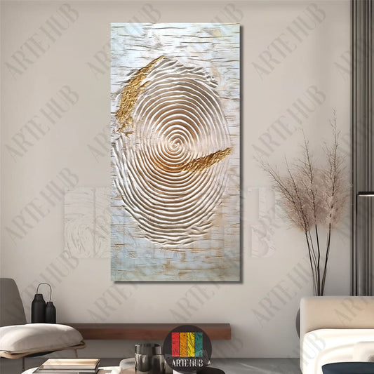 Modern abstract canvas wall art featuring concentric textured ripples with gold leaf accents and a central blue dot in a minimalist Egyptian living room.
